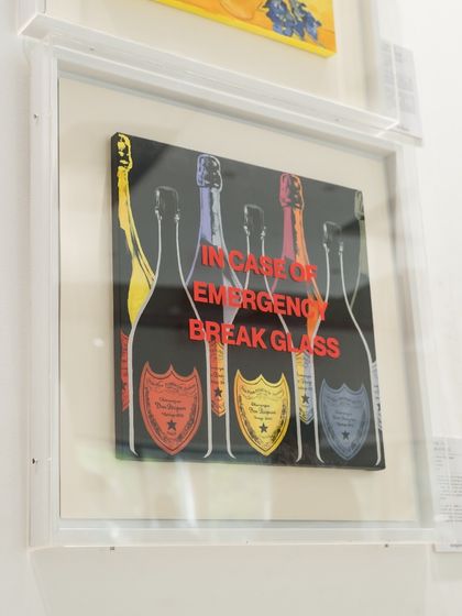 Another angle of the Warhol-inspired champagne piece, its bold red text a stark command against the colorful bottles.