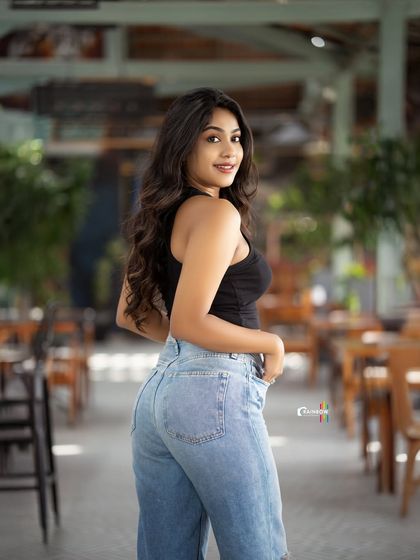 A casual and confident shot in a cafe, with the model looking back over her shoulder.