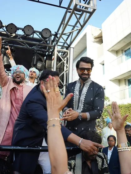 High fives and happy faces all around. The energy of a Baraat is infectious, and I'm there to amplify it.