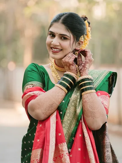 A charming portrait of the bride adjusting her earring. This candid gesture adds a touch of personality and grace to her bridal photos.