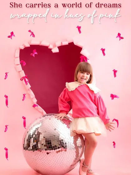 This Valentine's themed portrait features a smiling girl with a disco ball, overlaid with the text "She carries a world of dreams wrapped in hues of pink." It's an aspirational and beautifully styled image.