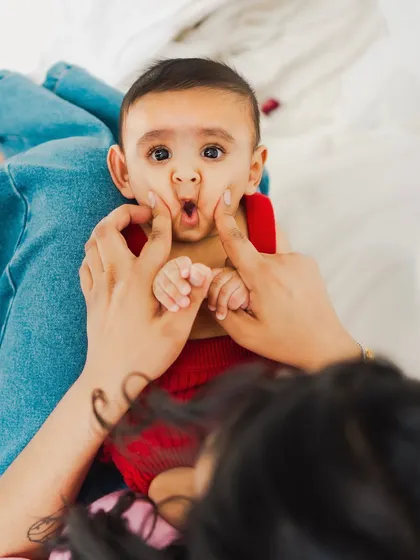 Just mommy things. A playful moment between a mother and her baby, full of giggles and fun.