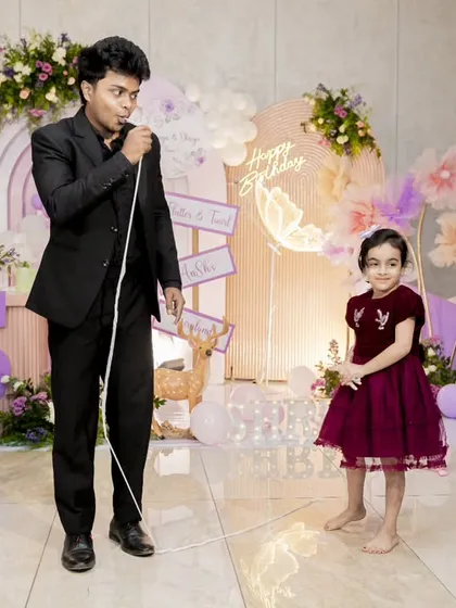 I love making the birthday child the star of the show. Here, I'm sharing a magical moment with a young volunteer during her party. My goal is to make their special day even more memorable.
