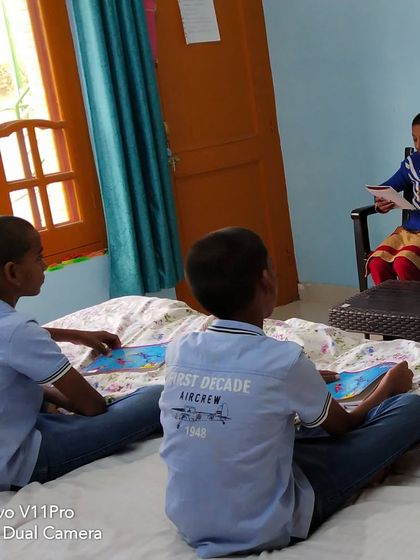 My sons listening to another child read. In our unschooling model, learning was a two way street. Everyone was both a teacher and a student, which created a beautiful environment of mutual respect and curiosity.