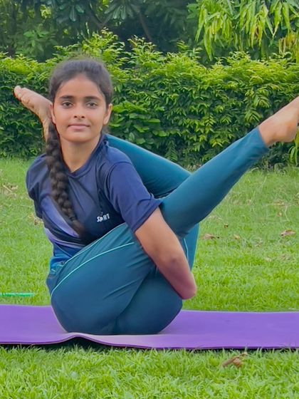 The Parivrtta Eka Pada Sirsasana, a revolved head-to-knee pose, is an advanced twist that this young yogi performs with precision.