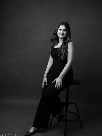 A black and white portrait adds a layer of classic sophistication. This seated pose is strong and timeless, perfect for a professional looking to convey both authority and grace.