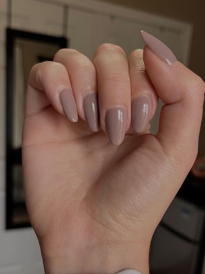 A lovely neutral mauve shade on almond-shaped nails. This is a great everyday color that's both professional and pretty.