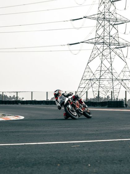 A rider on a KTM cornering at the CoASTT track.