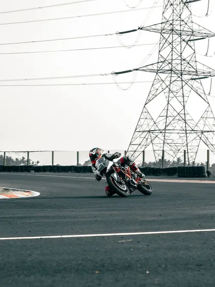 A rider on a KTM cornering at the CoASTT track.