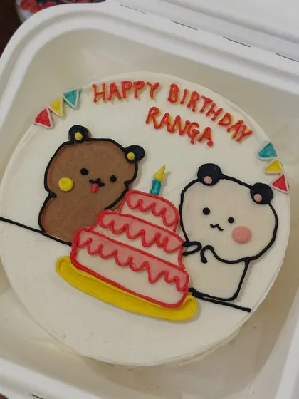 An adorable birthday bento featuring two cute bears and a tiny three-tier cake. This kind of detailed character work is one of our favorite things to do on our mini cakes.