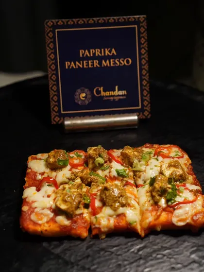 Paprika Paneer Messo, a fusion pizza-like flatbread topped with spicy paneer tikka. It's a great example of how I blend Indian flavors with global concepts.