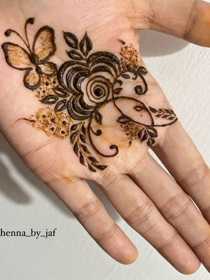 A whimsical design featuring a butterfly and a rose on the palm, perfect for someone who wants something unique and delicate.