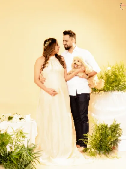 Bringing the whole family together, including the furry members. This couple's portrait includes their beloved dog, making it a true family photo.