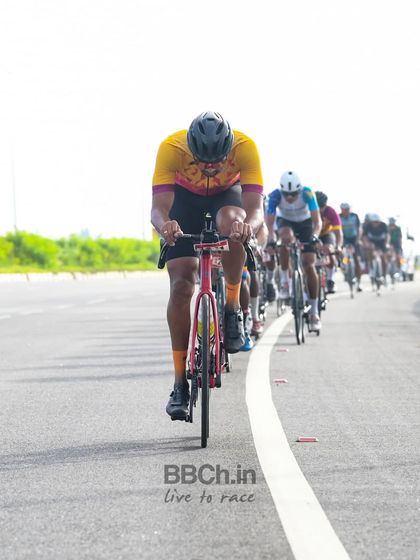 A rider from the masters category leads the peloton, setting a strong pace for the group.