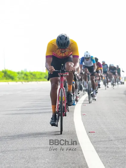 A rider from the masters category leads the peloton, setting a strong pace for the group.