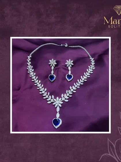 Elegance redefined. This diamond necklace, with its leaf-like design and heart-shaped sapphire drops, speaks the language of luxury and sophistication.