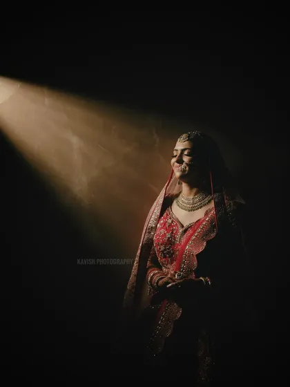 The bride turns towards the light with a gentle smile, her face illuminated beautifully. This portrait is both artistic and emotional, a signature style of my wedding photography.
