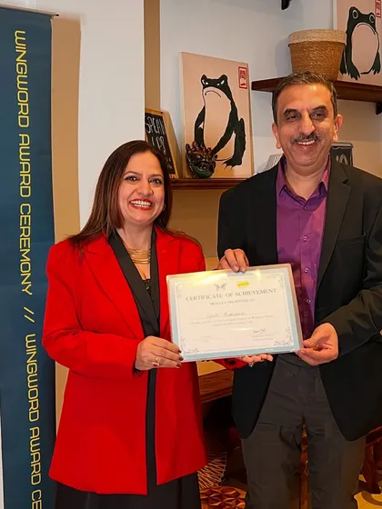 A winner receives his certificate of achievement at the Wingword award ceremony.