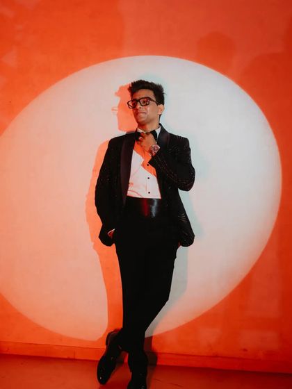 A stylish portrait of the groom-to-be in a tuxedo, posed against a spotlight. This shot has a classic, fine-art feel, highlighting his personality with a touch of drama.