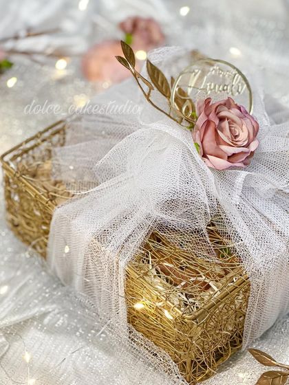 A side view of the wrapped mesh box hamper, showing how the light catches the golden details. I love making sure the packaging is as special as the treats inside.