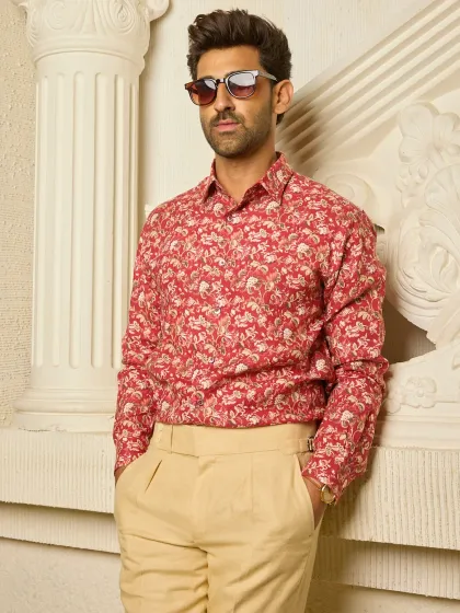 This long-sleeved linen shirt, with its understated red and beige floral print, is a perfect example of how I blend quiet charm with effortless elegance in my casual wear.