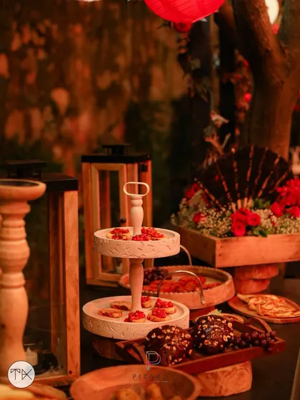 It's all about the details. We curated this food display with rustic elements like wooden serving platters, tiered stands, and ambient lanterns to create a spread that was as visually appealing as it was delicious.