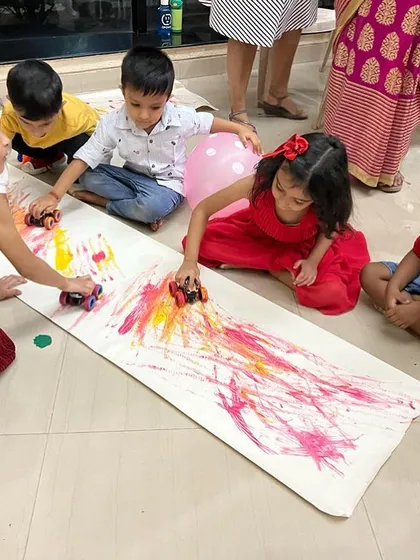 Process art is all about the experience, not the final picture. This car track painting activity is always a huge hit. It’s a fun, large-scale way for kids to explore color mixing and movement.