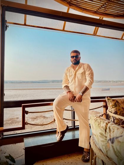 A client enjoying a beachside view in a custom-tailored, off-white corduroy co-ord set. This demonstrates my ability to create stylish, comfortable resort wear with a perfect bespoke fit.