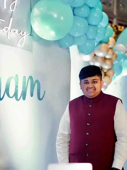 The birthday boy, Shubham, standing in front of the stage we designed for his 15th birthday party.