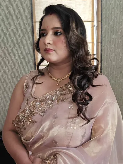 A three-quarter profile view of the final party look. The hairstyle has just enough volume to feel special without overpowering her delicate features.