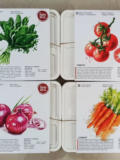 Our corporate lunch orders rolling out for delivery. We use these biodegradable boxes with custom-designed sleeves that share fun facts about the fresh ingredients used in your meal, like spinach, tomatoes, onions, and carrots.