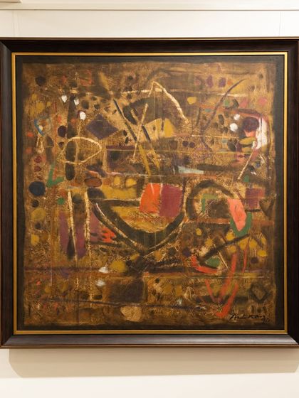 This 1990 abstract by Achutan Kudallur features deep oranges and golds interlocking like a labyrinth, showcasing his ability to create structured chaos and emotional depth.