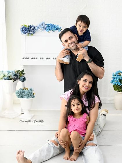 A playful and happy family portrait. With the little one on dad's shoulders, this image captures the fun and energy of a young family.