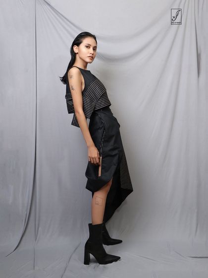 A side view that gives a clear look at the construction of the garment and the model's edgy styling.