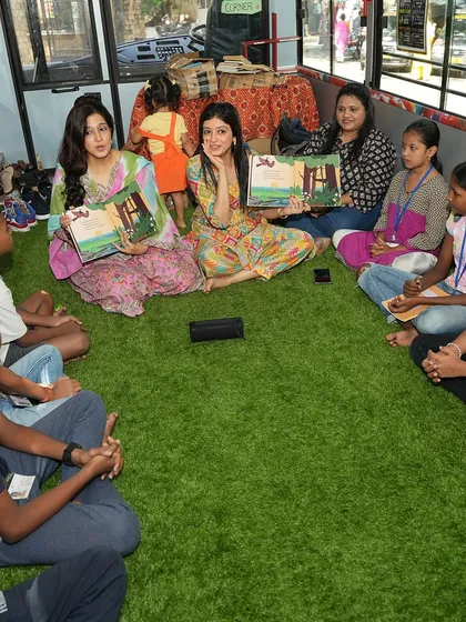 Our co-founders holding up the 'Jungle Jugalbandi' book during a reading session on the music bus.