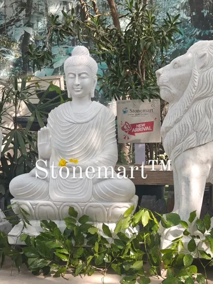The combination of the serene Buddha and powerful lions creates a unique and balanced aesthetic. These statues are carved from solid blocks of white marble and are built to withstand the elements.