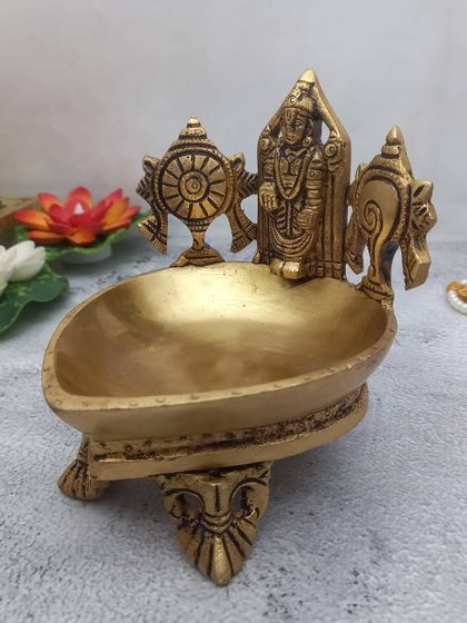 Another view of the brass Tirupati Balaji deepam, showing the fine details and the sturdy elephant-leg stand.