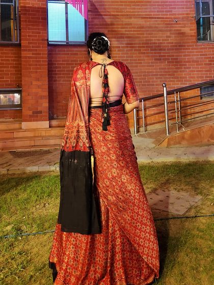 A back view of the lehenga, showcasing the elegant hairstyle and the detailed design of the blouse.