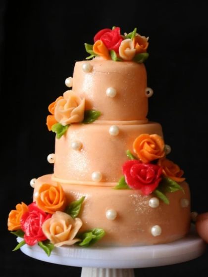 A close-up of my three-tiered floral wedding cake miniature.