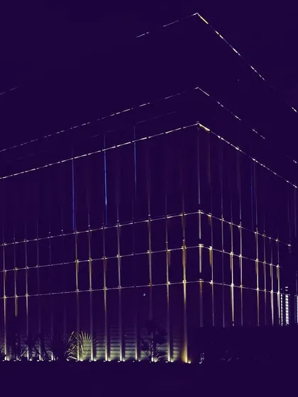 A wide-angle shot of the Zirakpur office project, showing how the illuminated facade establishes a strong presence. The design uses light to define the building's entire volume against the night sky.