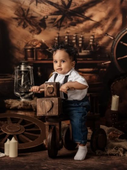 This little pirate is focused on his next move, interacting with wooden blocks in a scene straight out of a storybook.