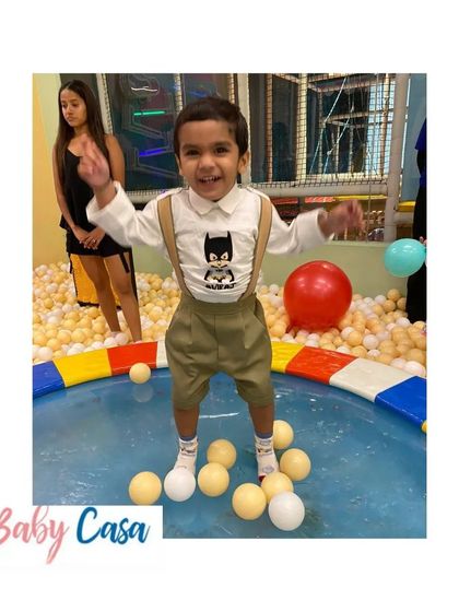 Even in the ball pit, he's the hero. This little boy is having a blast at his birthday party in our comfortable Batman-themed suspender set.