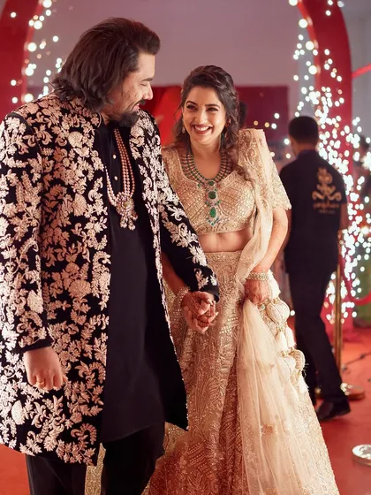 There is nothing more rewarding than seeing the joy of a couple on their special day. I designed her shimmering gold lehenga and his bespoke embroidered jacket to create a harmonious look, ensuring they shine together as they begin their new chapter.
