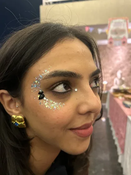 A bold crescent of silver glitter with a few black gems for contrast. This is a great look for a concert or a festival.
