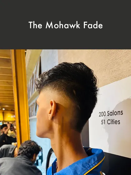 For a contemporary and edgy look, I offer The Mohawk Fade. This style combines the classic mohawk shape with a gradual fade on the sides, creating a dynamic and textured haircut that stands out.