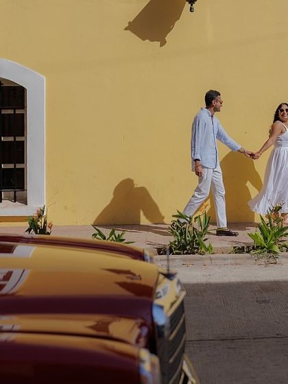 I love using foreground elements to create depth. Here, the vintage red car frames the couple as they walk along the colorful streets of Fontainhas, adding a layer of storytelling to the image.