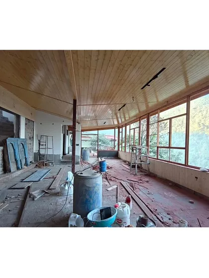 Another perspective of the interior under construction, showing the full length of the space. The design ensures that even from deep within the room, the connection to the outside is never lost.