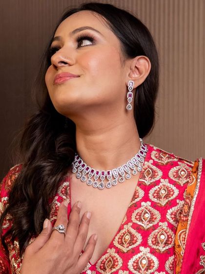 A close-up of a delicate diamond and ruby necklace set, a perfect rental to add a touch of color and sparkle to your outfit.