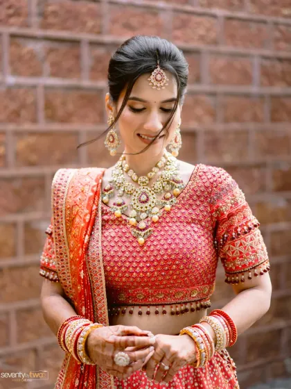 A bride in her stunning red Tarun Tahiliani lehenga, a portrait of grace amidst the natural beauty of Mahabaleshwar. The hills themselves seemed to celebrate her radiance.