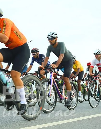 A rider takes a moment to refuel mid-race. Proper nutrition and hydration are critical for success in long-distance events.